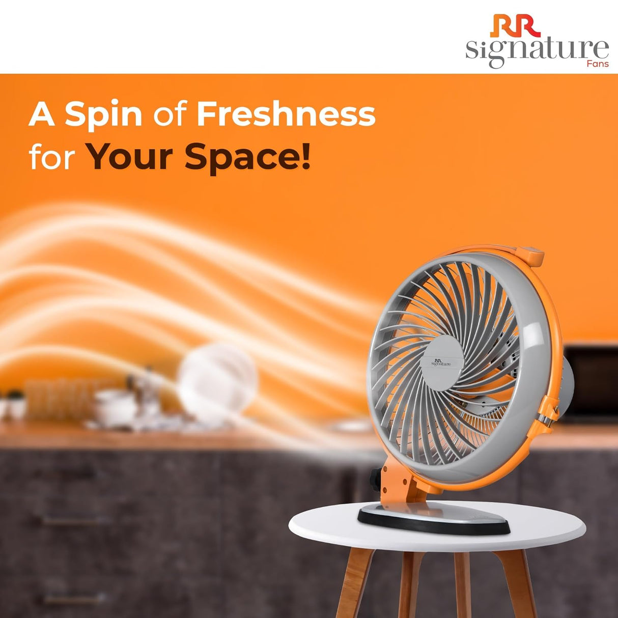 Orange fan with 'RR signature' branding on an orange background with text 'A Spin of Freshness for Your Space!'.