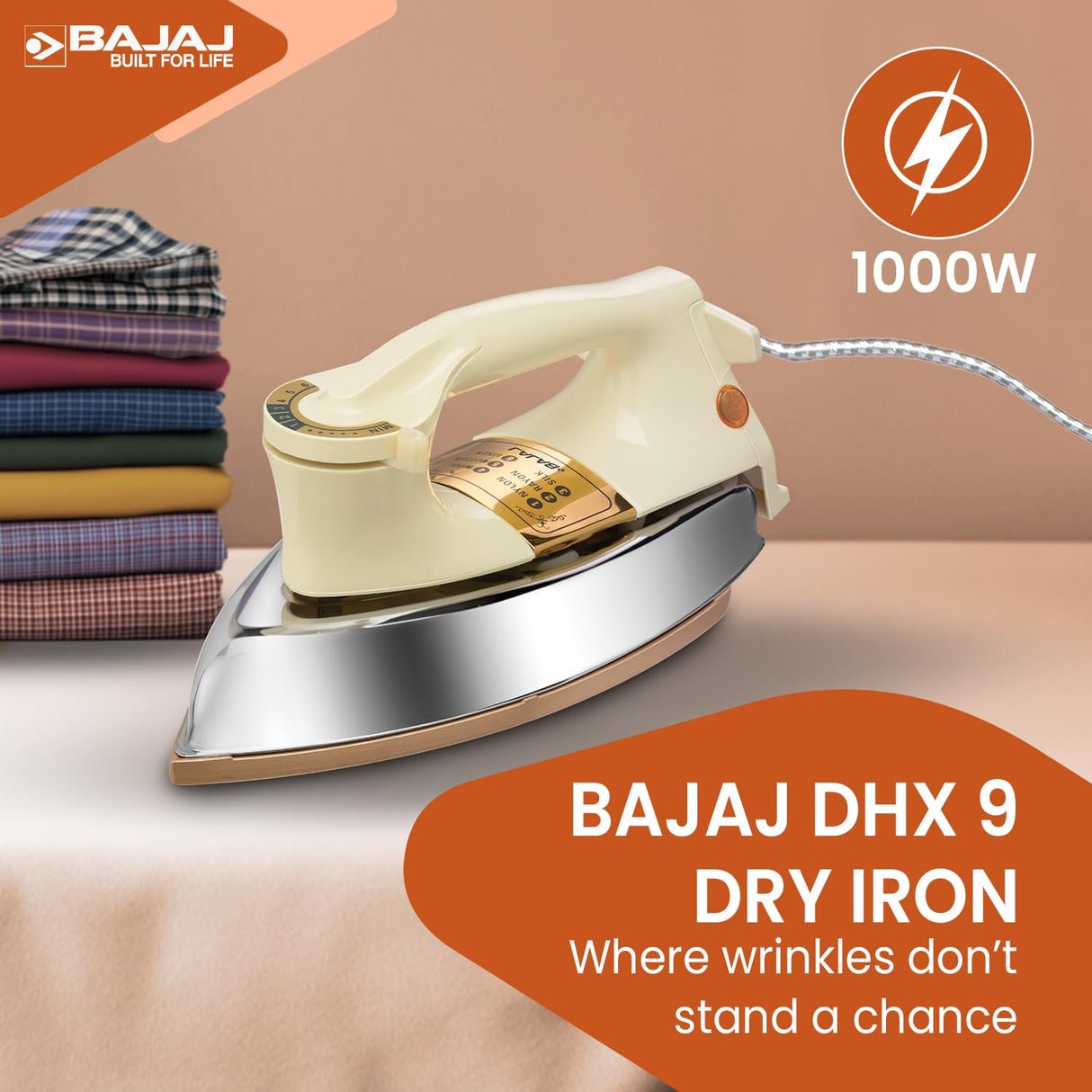 Bajaj DHX 9 dry iron with folded clothes on a table