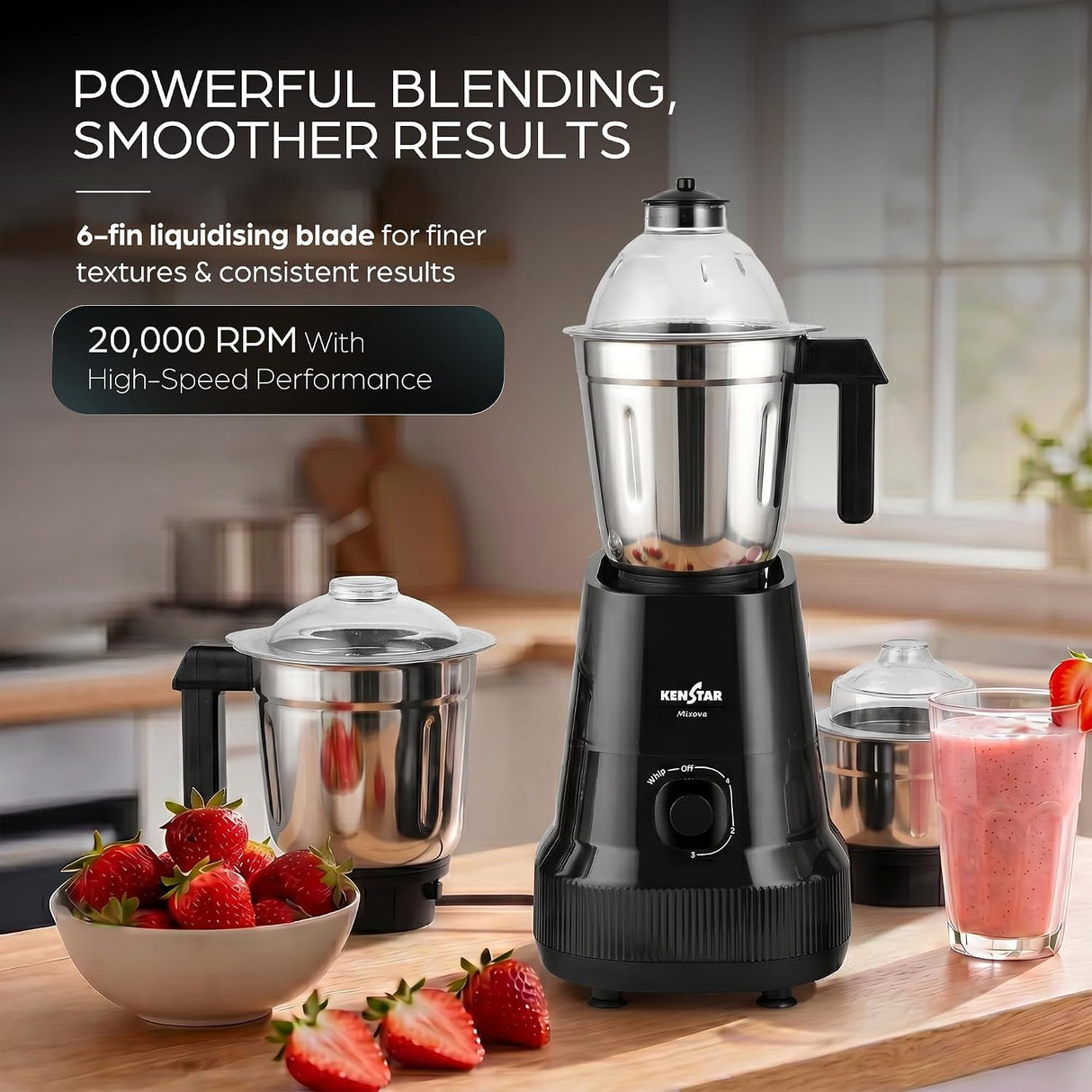 Kenstar countertop blender shown in a kitchen setting with promotional text. The main product is a black blender base with a clear lid and stainless steel jar, alongside two detachable jars and a pink drink.