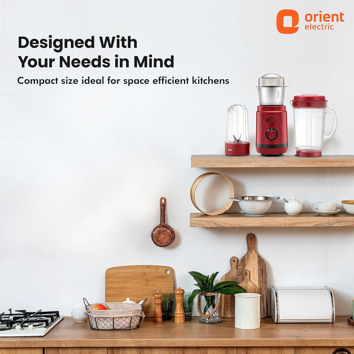 Red kitchen appliances on a wooden shelf with 'Orient Electric' branding.