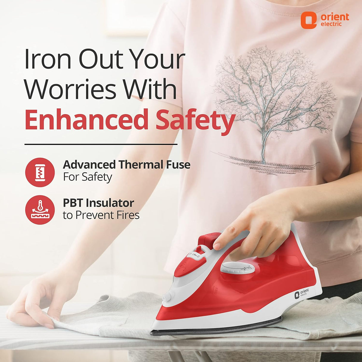 Person ironing with a red and white iron, featuring Orient Electric branding.