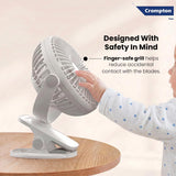 Crompton fan with a child's hand touching the safe grill design on a beige background
