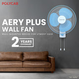 Wall-mounted fan with POLYCARB branding in a room with a brown sofa.