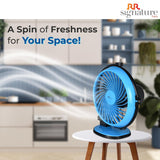 Blue fan on a small table with a blurred kitchen background and 'RR signature' branding.