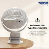 White portable fan with USB charging indicator on a wooden surface, featuring Crompton logo.