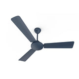 A denim blue Crompton Jura Prime 1200 mm ceiling fan with a contemporary design, featuring a sleek finish and three blades.