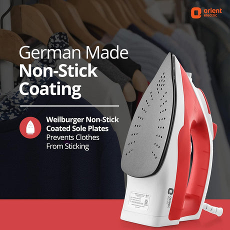 Red and white iron with German-made non-stick coating feature on a blurred background of clothes on hangers.
