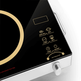 Close-up of a modern electric cooktop with control panel and display.