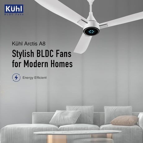 Köhl Arctis A8 BLDC fan in a modern living room setting with gray walls and a white sofa.