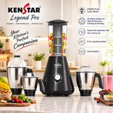 KenStar Legend Pro blender set displayed on a kitchen countertop with a blurred kitchen background. The set includes a black main blender base with a clear pitcher filled with fruit, a smaller black and silver chopper attachment, a second silver jar, and a small jar with lid.