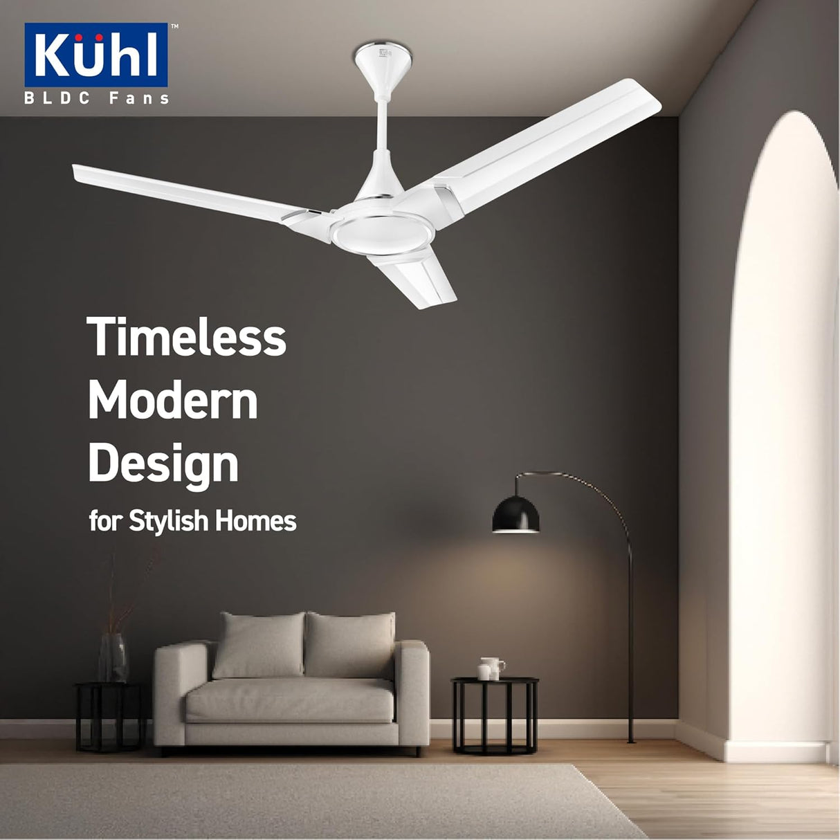 Modern living room with a ceiling fan, sofa, and lamp, featuring Kühl BLDC Fans branding.