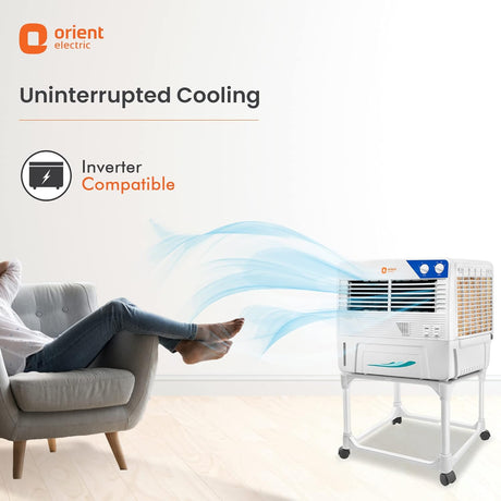 Orient Electric air cooler with person relaxing on a chair, emphasizing uninterrupted cooling.