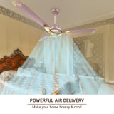 Ceiling fan with pink blades in a room with a canopy bed and decorative wall.