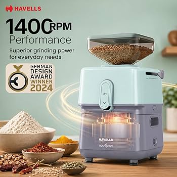 Grinding machine with ingredients on a wooden surface, featuring Havells branding and design award badge.