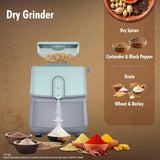 Dry grinder with ingredients like coriander, black pepper, wheat, and barley on a brown background.