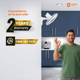 Advertisement for Orient Electric with a man in a kitchen and warranty information.