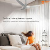 Ceiling fan in a room with a child sitting on a couch, featuring Orient Electric branding.