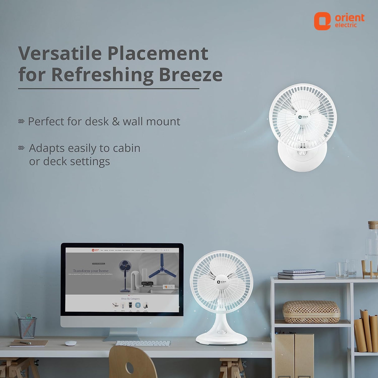 Wall-mounted and desk fan with text on a light blue wall, featuring Orient Electric branding.