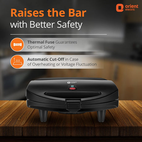 Black appliance with safety features highlighted on a wooden surface, branded as Orient Electric.