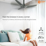 Ceiling fan in a room with a child sitting on a bed, featuring Orient Electric branding.