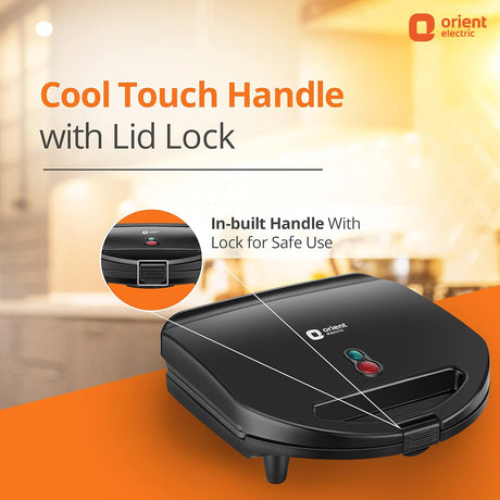 Black sandwich maker with cool touch handle and lid lock feature on an orange surface, Orient Electric brand visible.