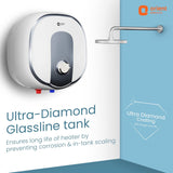 Orient Electric ultra-diamond glassline tank water heater shown mounted on a white wall in a bathroom setting, with a shower head above and promotional text highlighting corrosion prevention and tank longevity.