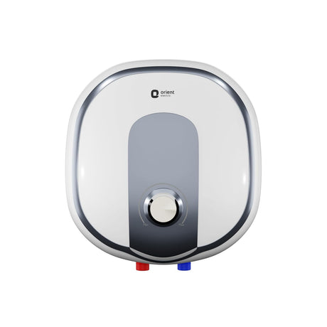 An electric water heater by Orient, featuring a white and silver rounded square design with a central gray panel and a central dial, shown against a plain white background.
