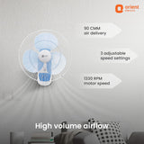 Wall-mounted fan with Orient Electric branding, showing features like air delivery and speed settings.