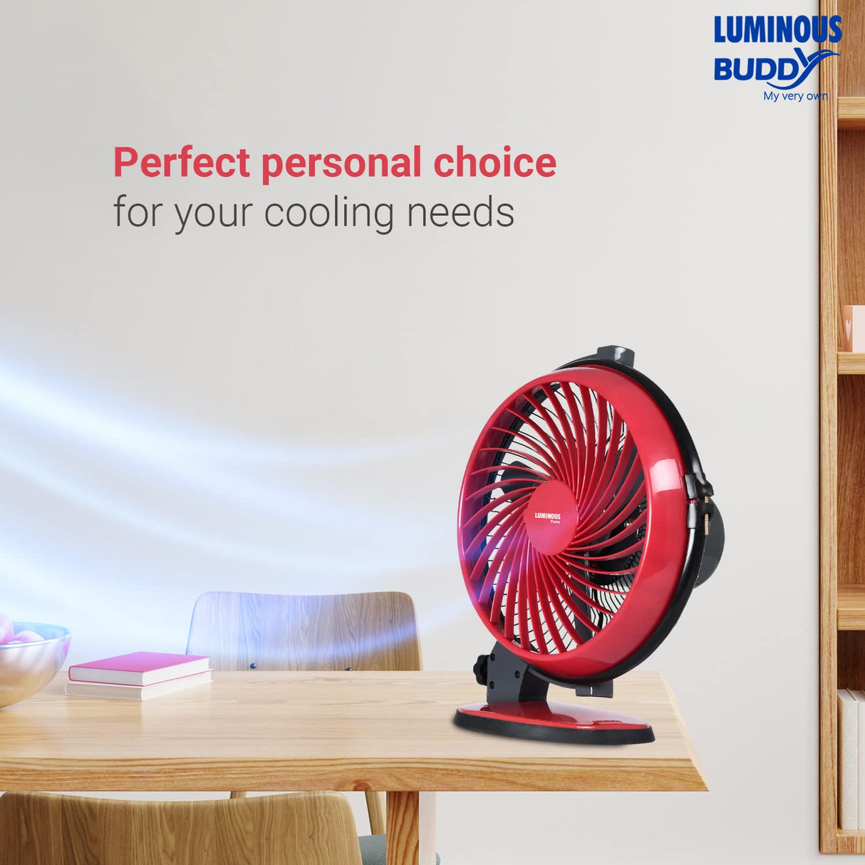 Red portable fan on a table with 'Luminous Buddy' branding and text about personal choice for cooling needs.