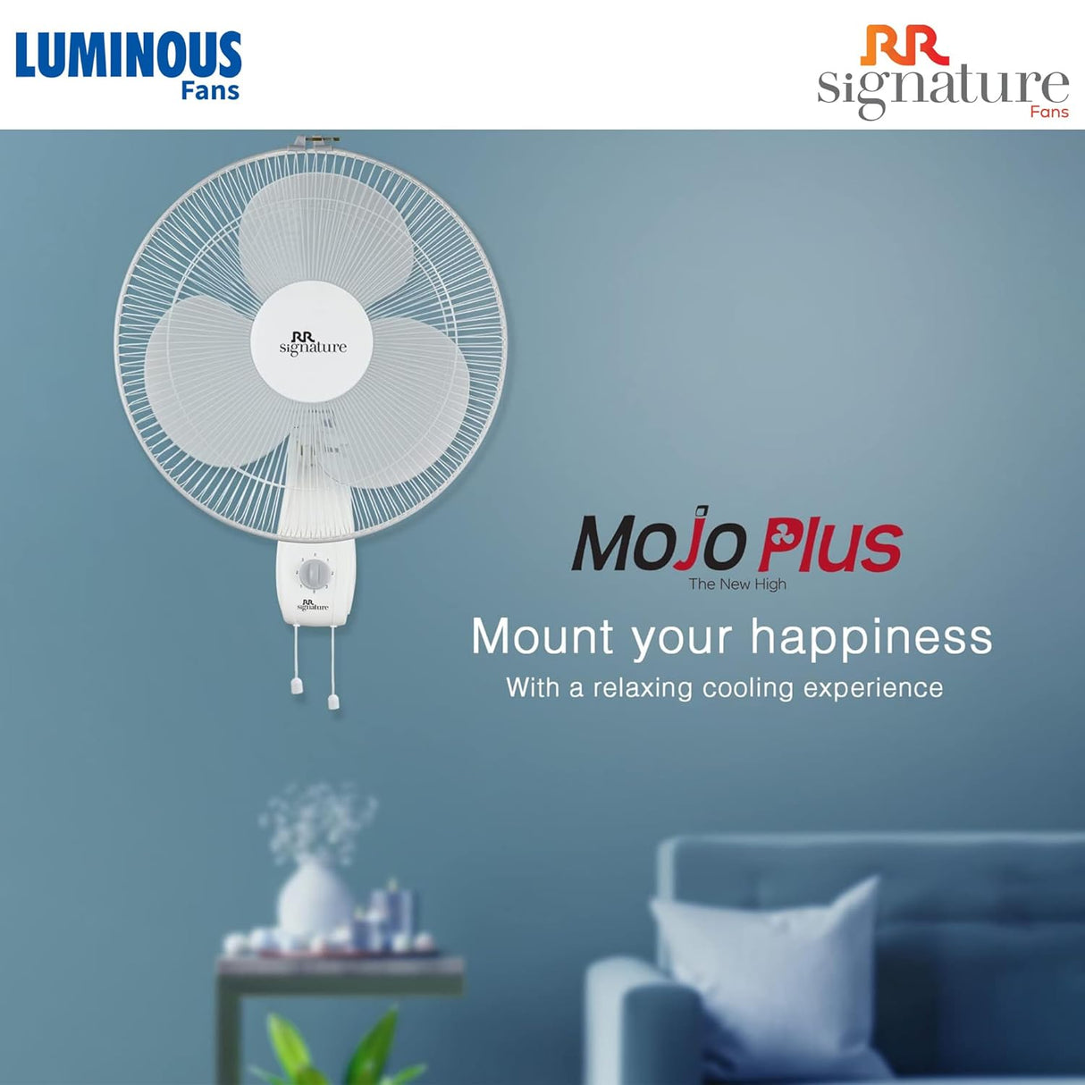 Wall-mounted fan with Luminous and RR Signature branding in a room setting.