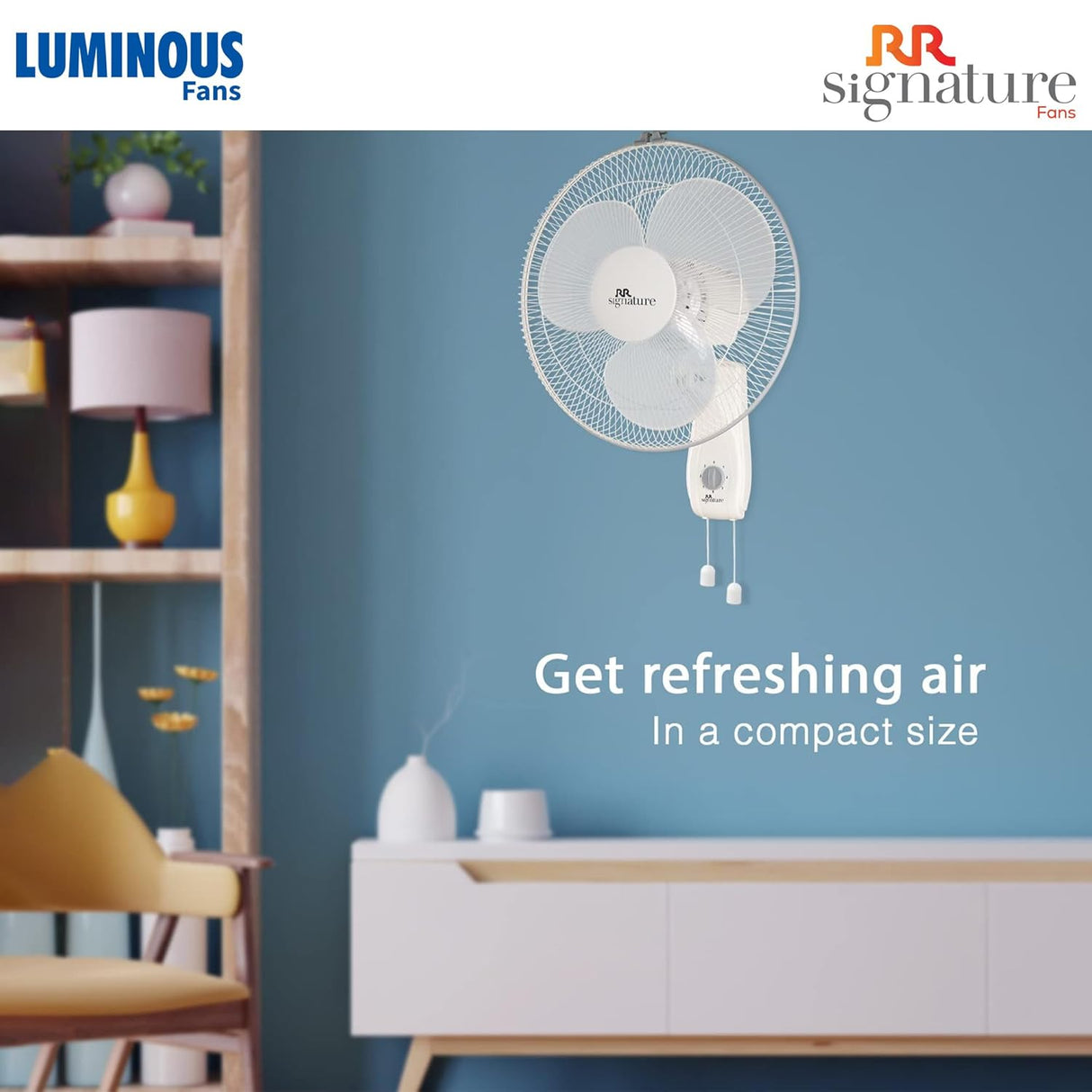 Wall-mounted fan on a blue wall with Luminous and RR Signature branding.