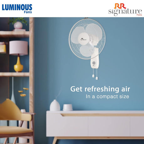 Wall-mounted fan on a blue wall with Luminous and RR Signature branding.