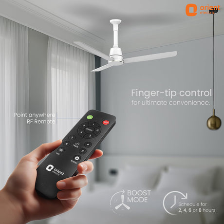 Hand holding a remote control with a ceiling fan in the background, featuring Orient Electric branding.
